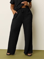 Yours Curve Black Wide Fit Bubble Texture Wide Leg Trousers - Image 1 of 5