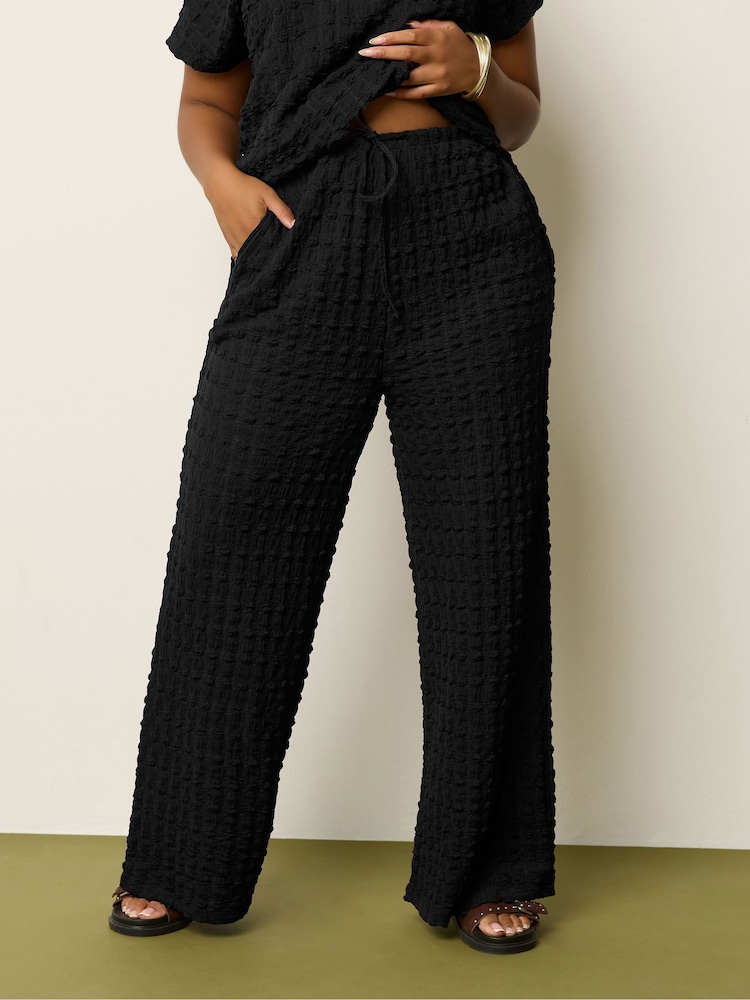 Yours Curve Black Wide Fit Bubble Texture Wide Leg Trousers - Image 1 of 5