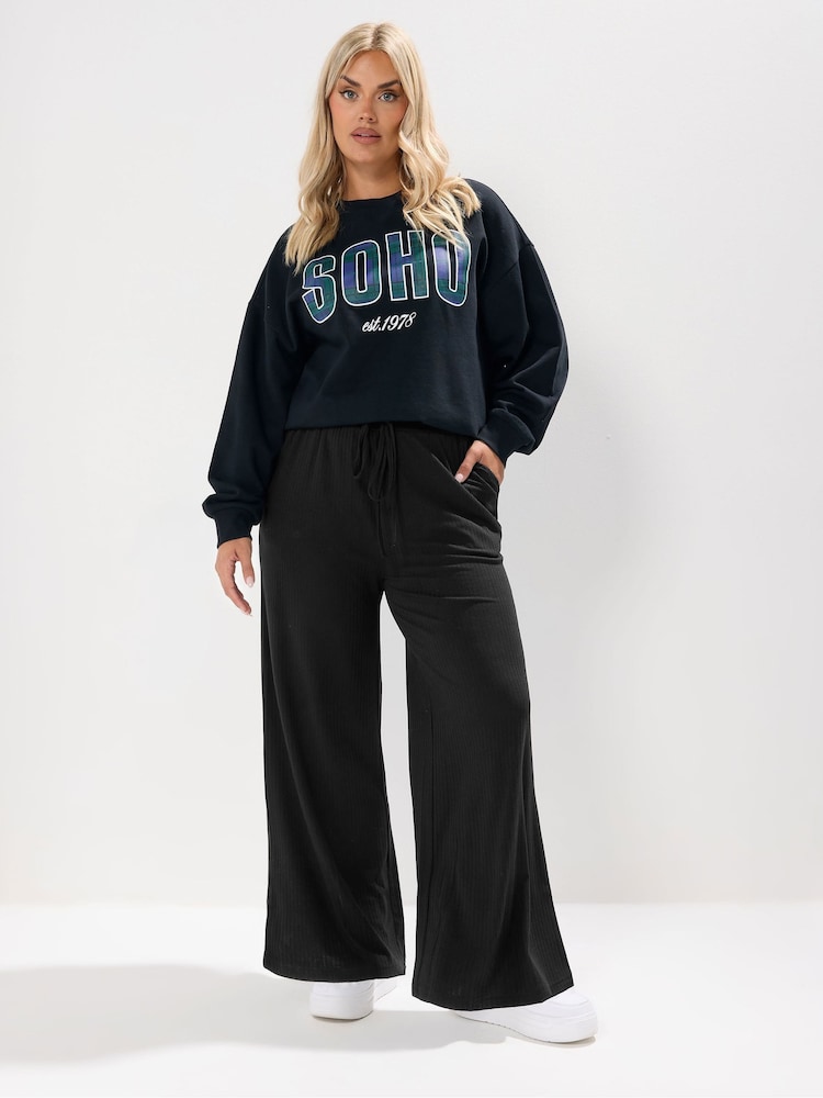 Yours Curve Black Wide Leg Ribbed Pull On Trousers - Image 1 of 5 Yours Curve Black Wide Leg Ribbed Pull On Trousers - Image 1 of 5