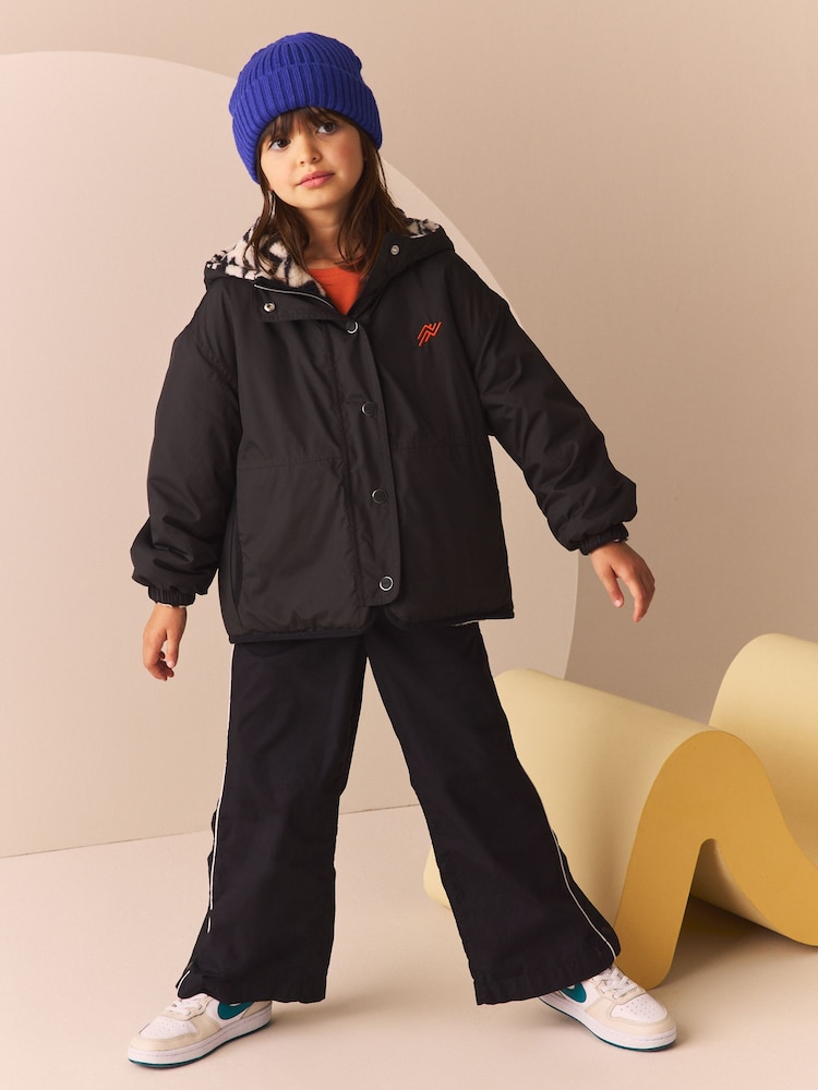 Black/White Reversible Aztec Printed Borg Fleece and Nylon Jacket (3-12yrs) - Image 2 of 7