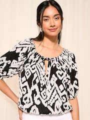 Friends Like These Black and White Ikat Tie Neck Bubble Hem Puff Sleeve Top - Image 1 of 4