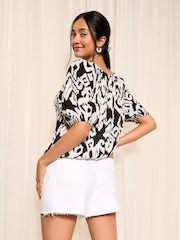 Friends Like These Black and White Ikat Tie Neck Bubble Hem Puff Sleeve Top - Image 4 of 4