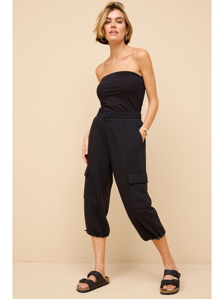 Black Slinky Capri 3/4 Length Crop Cargo Trousers - Image 1 of 7 Black Slinky Capri 3/4 Length Crop Cargo Trousers - Image 1 of 7