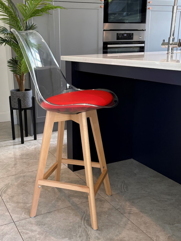 Fusion Living Red Soho Clear Plastic Bar Stool with Light Wood Legs - Image 1 of 5 Fusion Living Red Soho Clear Plastic Bar Stool with Light Wood Legs - Image 1 of 5