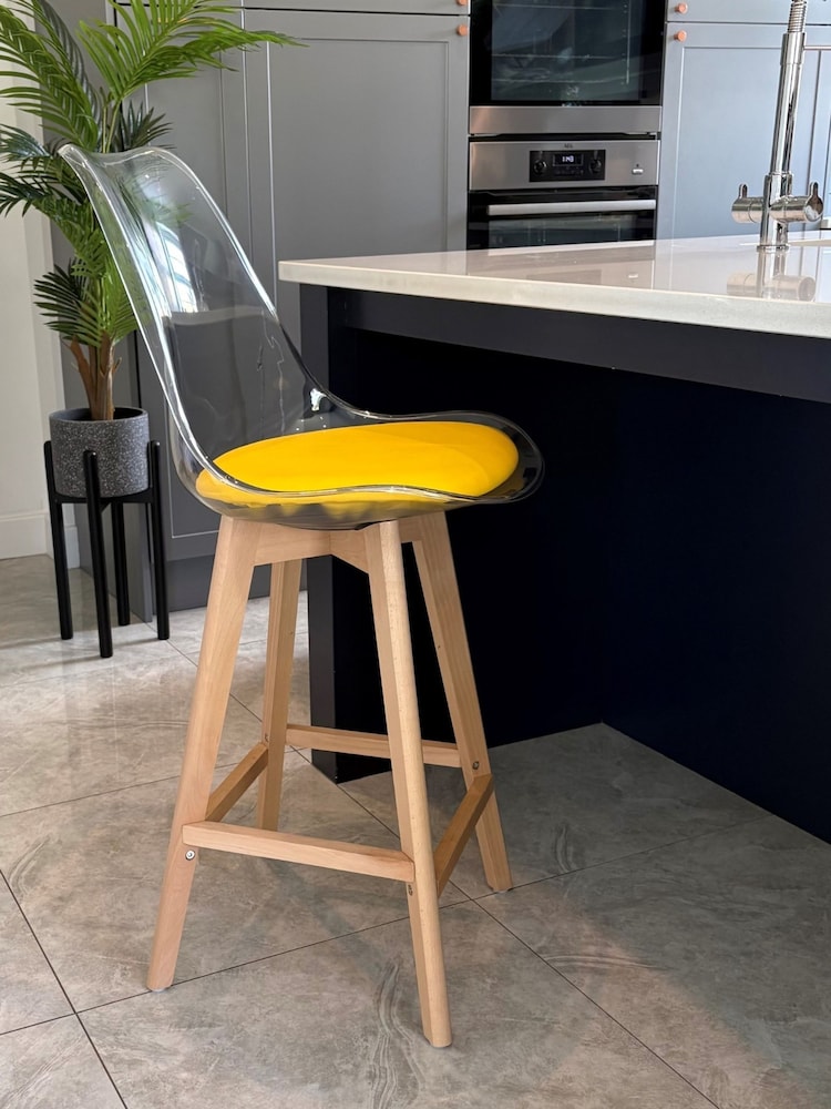 Fusion Living Yellow Soho Clear Plastic Bar Stool with Light Wood Legs - Image 1 of 5 Fusion Living Yellow Soho Clear Plastic Bar Stool with Light Wood Legs - Image 1 of 5