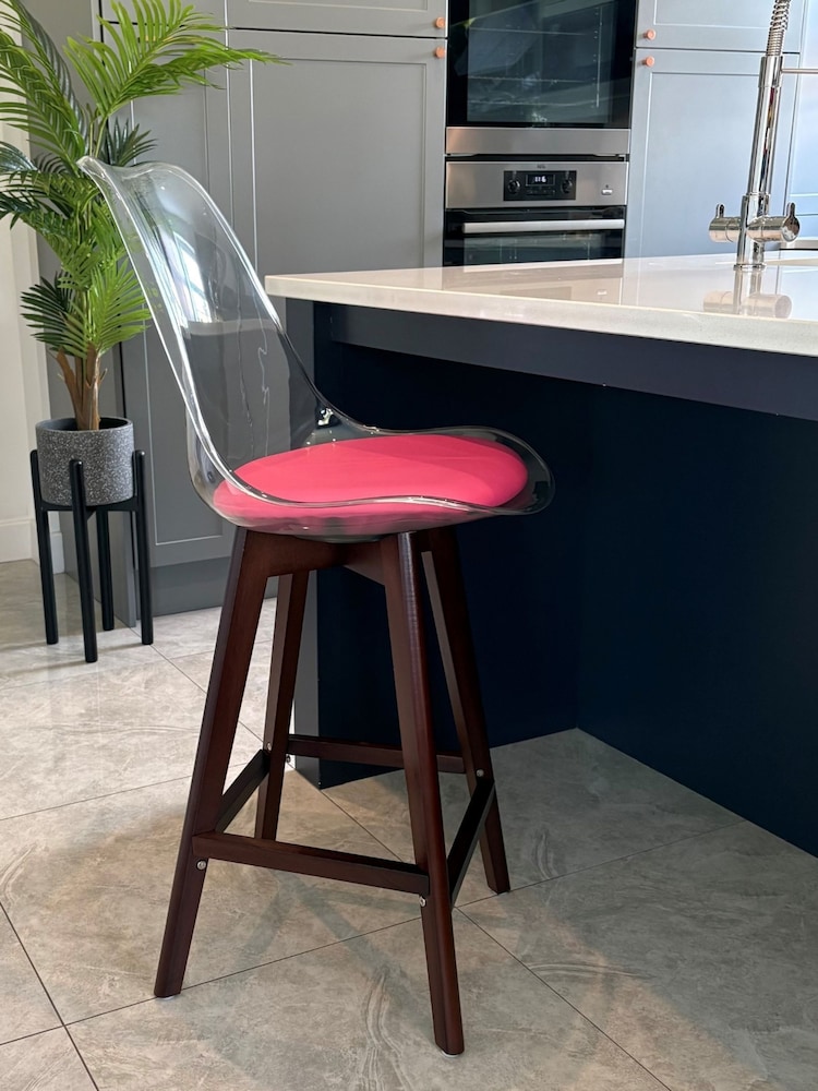 Fusion Living Bright Pink Soho Clear Plastic Bar Stool with Dark Wood Legs - Image 1 of 5
