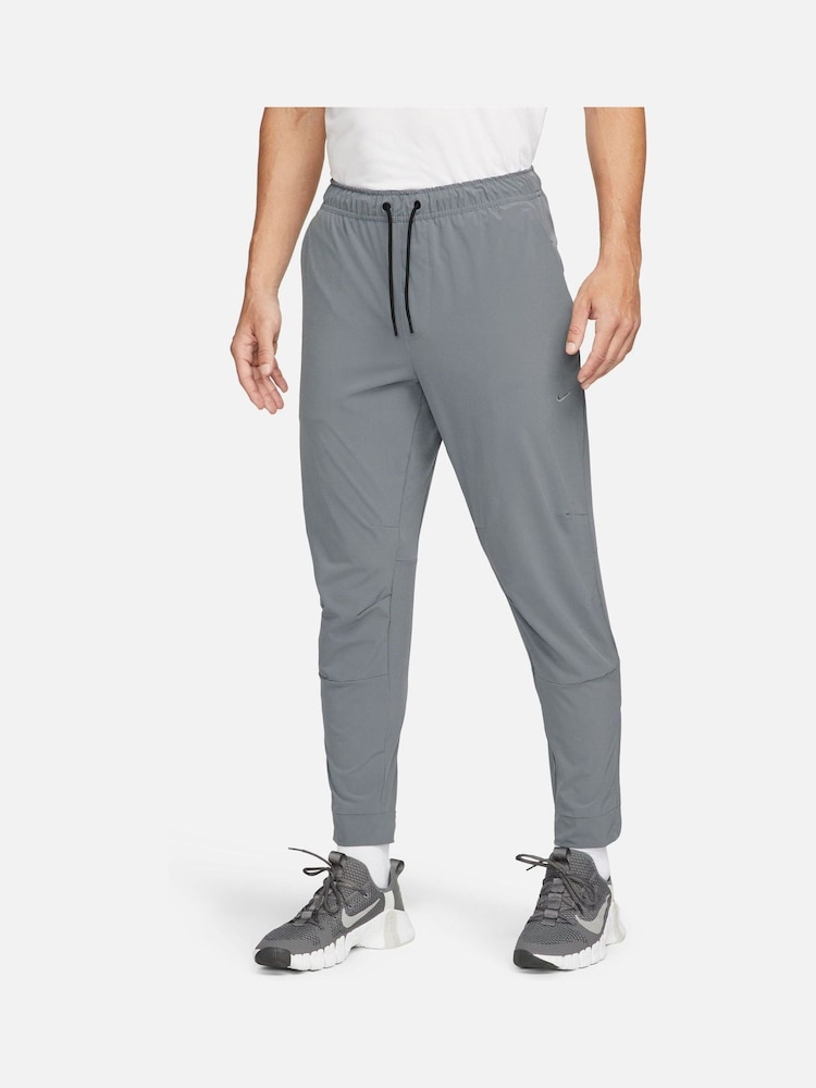 Серый - Nike Unlimited Спортивные брюки на молнии Dri-FIT - Изображение 1 из 12