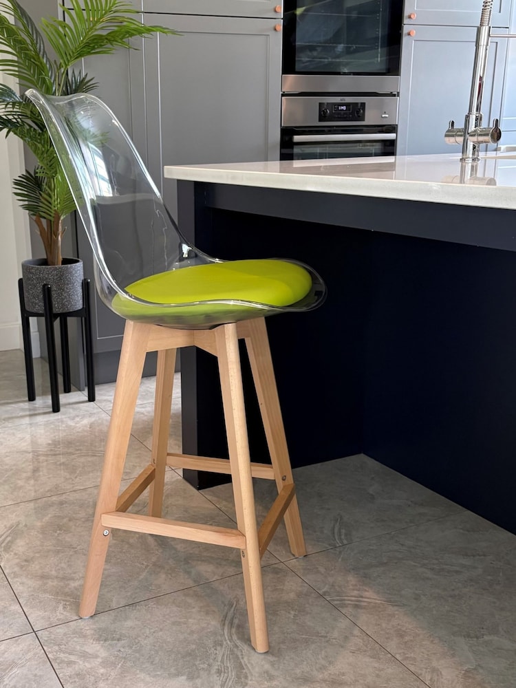 Fusion Living Green Soho Clear Plastic Bar Stool with Light Wood Legs - Image 1 of 5 Fusion Living Green Soho Clear Plastic Bar Stool with Light Wood Legs - Image 1 of 5