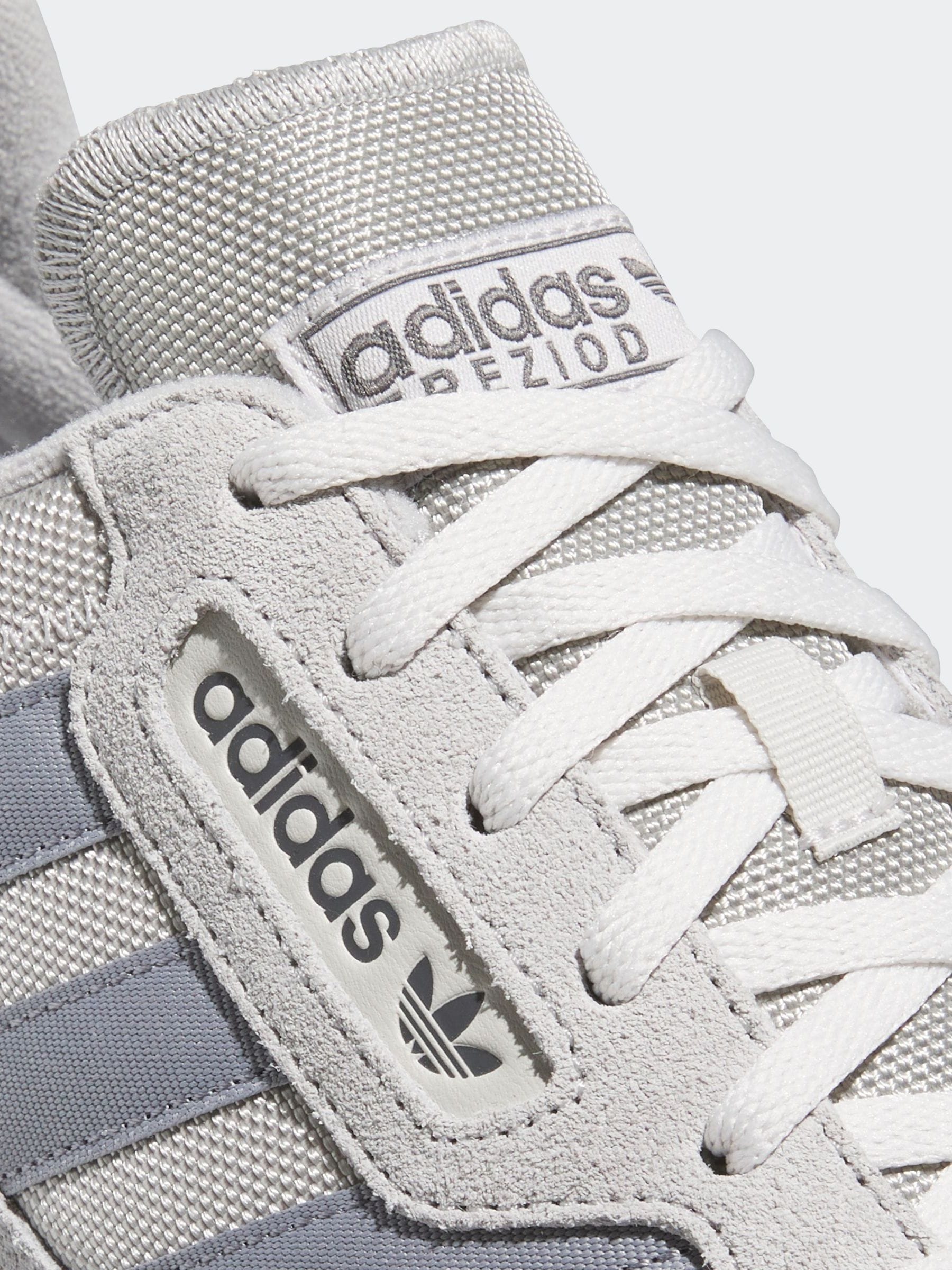 Light grey adidas trainers 2025