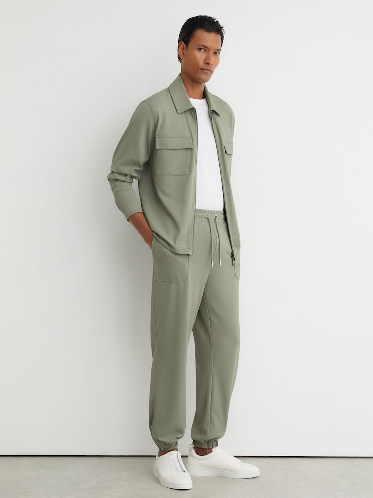 Reiss Sage Green Crescent R-Flex Stretch-Twill Cuffed Joggers - Image 1 of 9 Reiss Sage Green Crescent R-Flex Stretch-Twill Cuffed Joggers - Image 1 of 9