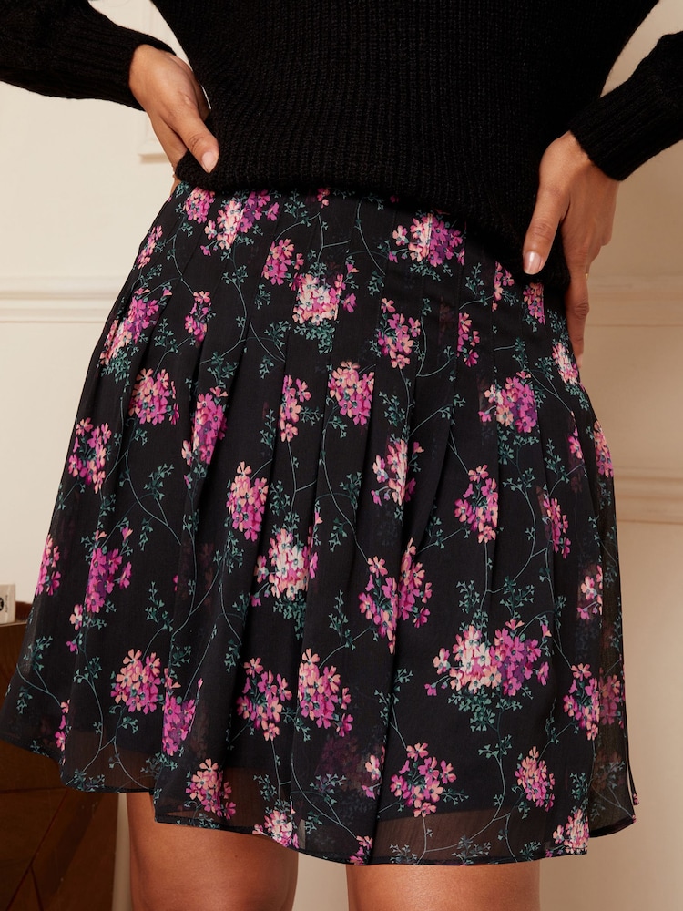 Love & Roses Purple Floral Pleated Mini Skirt - Image 1 of 4 Love & Roses Purple Floral Pleated Mini Skirt - Image 1 of 4