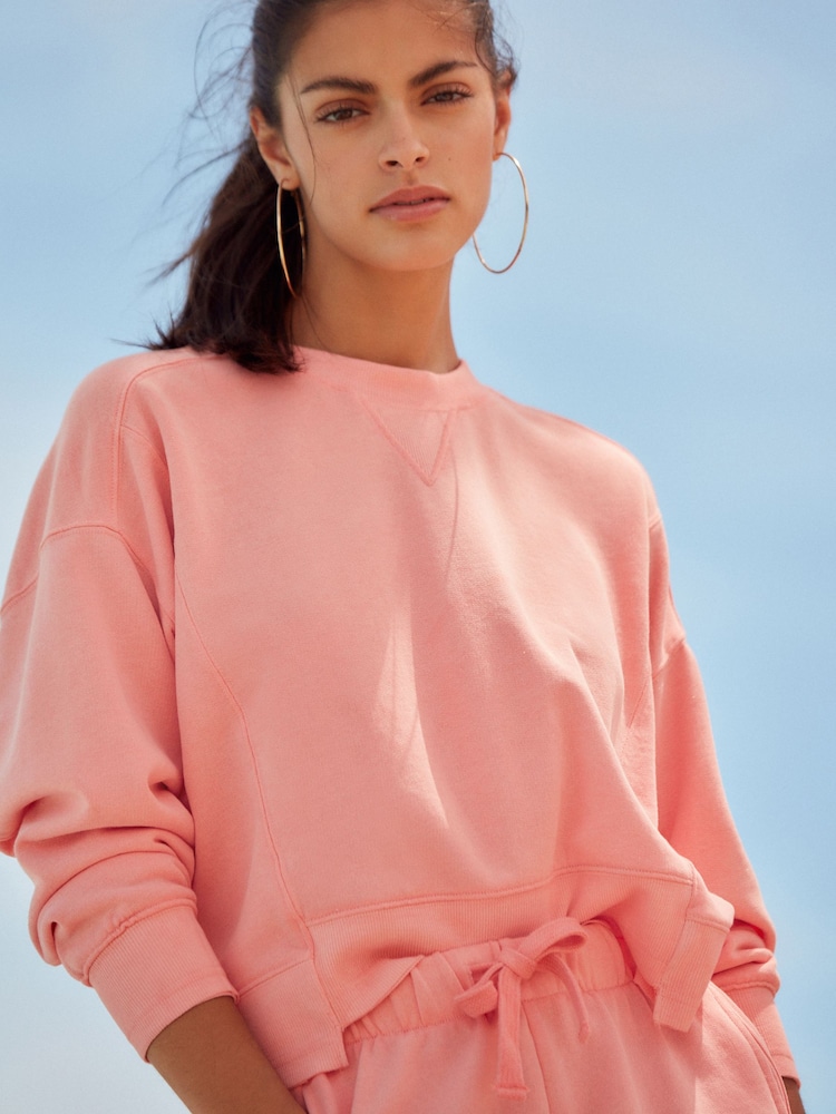 Grapefruit Pink Raw Hem Detail Washed Crew Neck Sweatshirt - Image 1 of 6 Grapefruit Pink Raw Hem Detail Washed Crew Neck Sweatshirt - Image 1 of 6
