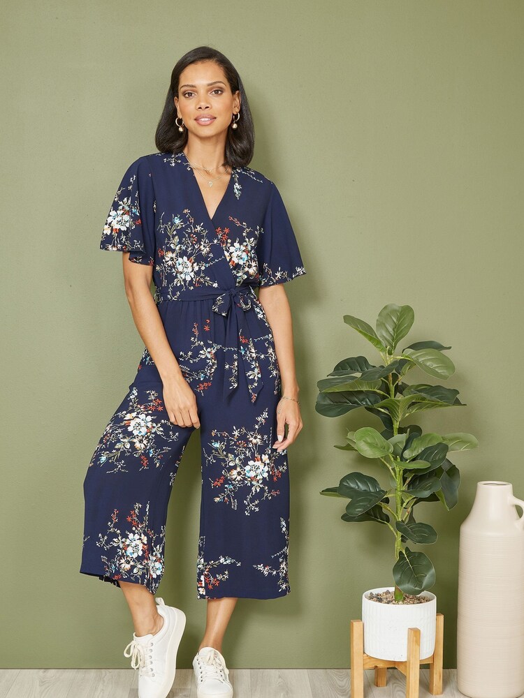 Mela Blue Floral Print Jumpsuit With Angel Sleeves - Image 1 of 5 Mela Blue Floral Print Jumpsuit With Angel Sleeves - Image 1 of 5