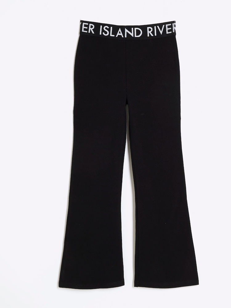 River Island Black Girls Deep 100% Cotton Waistband Kickflare Trousers - Image 1 of 3 River Island Black Girls Deep 100% Cotton Waistband Kickflare Trousers - Image 1 of 3