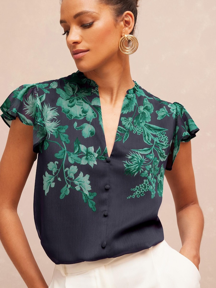 V&A | Love & Roses Teal Floral Printed Ruffle V Neck Flutter Sleeve Button Up Blouse - Image 1 of 4 V&A | Love & Roses Teal Floral Printed Ruffle V Neck Flutter Sleeve Button Up Blouse - Image 1 of 4