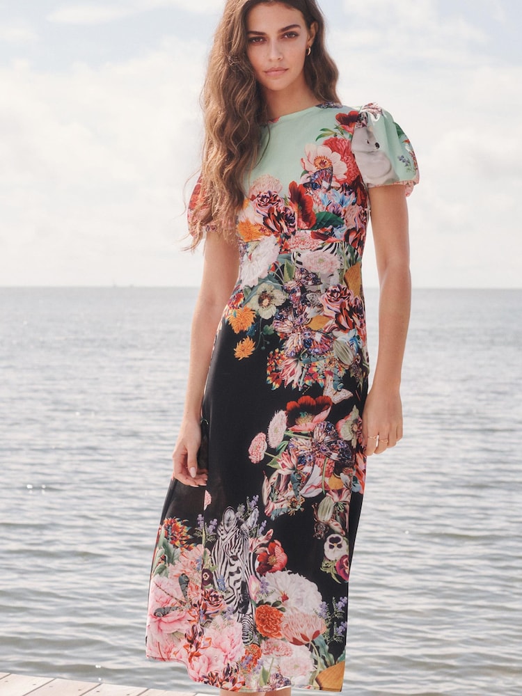 Mary Katrantzou x Lipsy Black Floral Short Sleeve Under Bust Midi Dress - Image 1 of 3 Mary Katrantzou x Lipsy Black Floral Short Sleeve Under Bust Midi Dress - Image 1 of 3