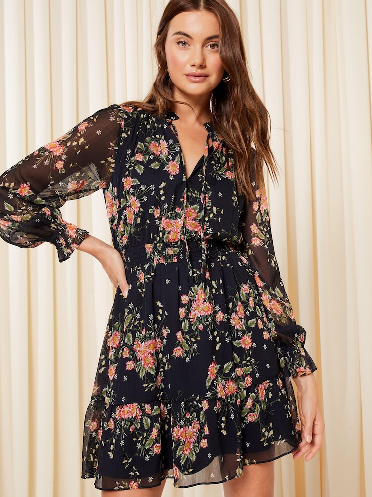 Friends Like These Navy Blue Floral Chiffon Tie Neck Ruffle Hem Mini Dress - Image 1 of 4 Friends Like These Navy Blue Floral Chiffon Tie Neck Ruffle Hem Mini Dress - Image 1 of 4