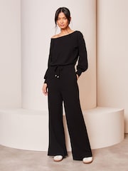 Lipsy Black Petite Cosy Off The Shoulder Long Sleeve Jumpsuit - Image 1 of 4