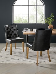 Set of 2 Distressed Faux Leather Black Wolton Dark Wood Leg Collection Luxe Button Dining Chairs - Image 1 of 9