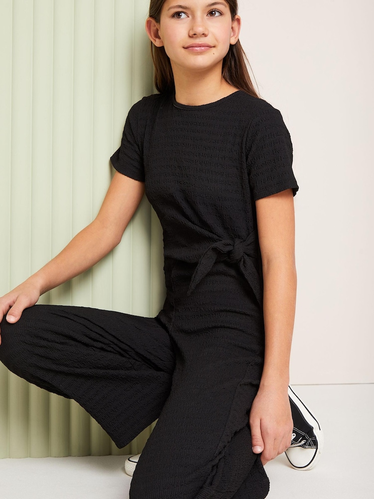 Lipsy Black Tie Side Crinkle Texture Jersey Jumpsuit (5-16yrs) - Image 2 of 2