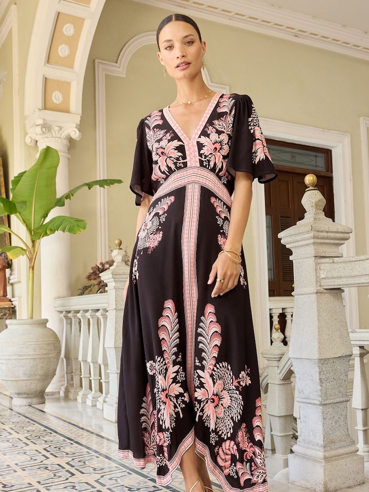 V&A | Love & Roses Pink and Black Printed V Neck Hanky Hem Midi Dress - Image 1 of 4 V&A | Love & Roses Pink and Black Printed V Neck Hanky Hem Midi Dress - Image 1 of 4