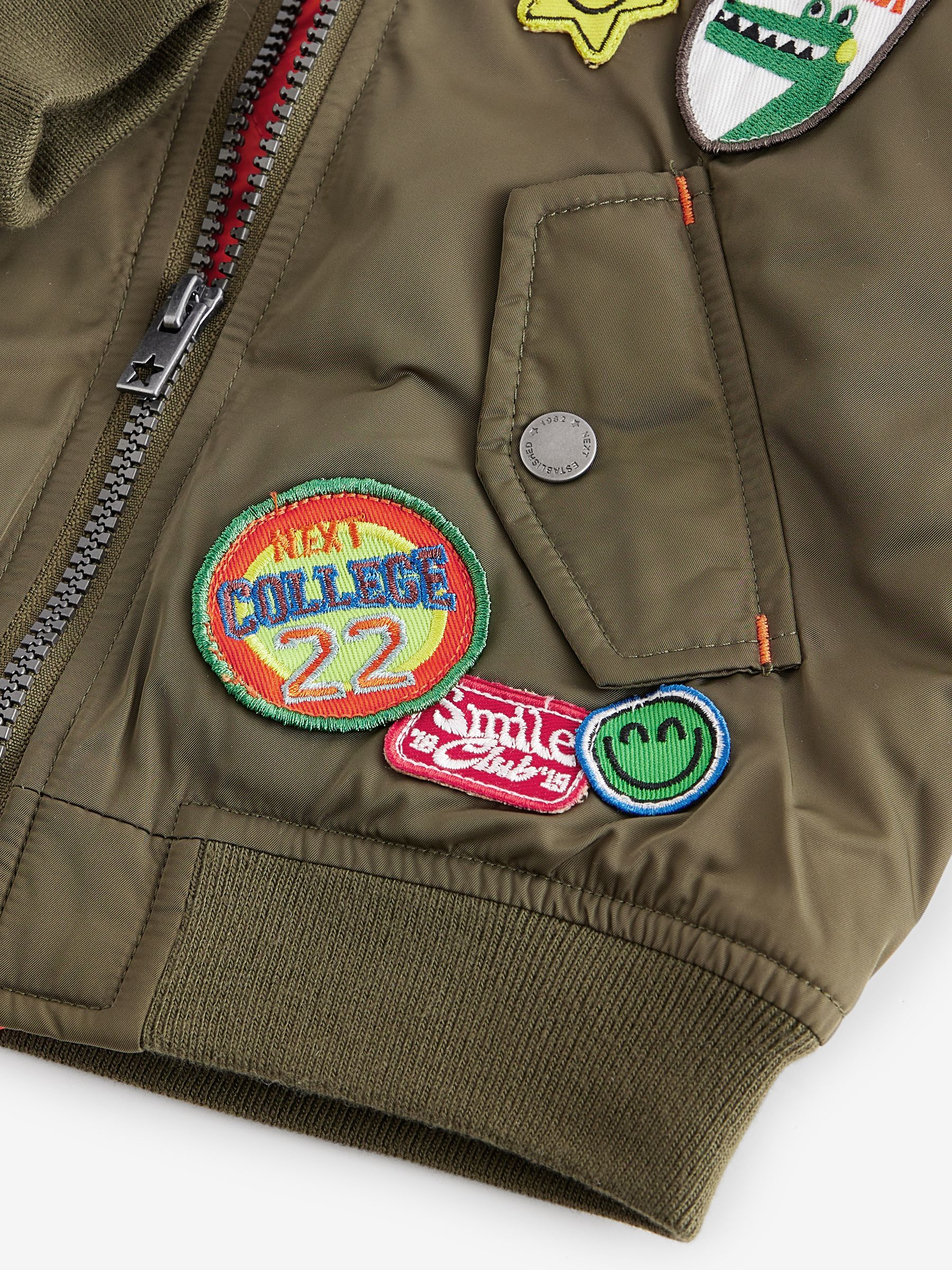 green bomber jacket with badges