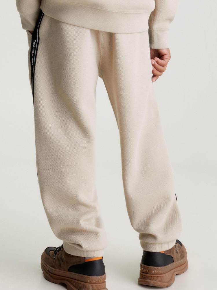 Calvin Klein Jeans Pique Interock Cream Joggers - Image 2 of 5 Calvin Klein Jeans Pique Interock Cream Joggers - Image 2 of 5