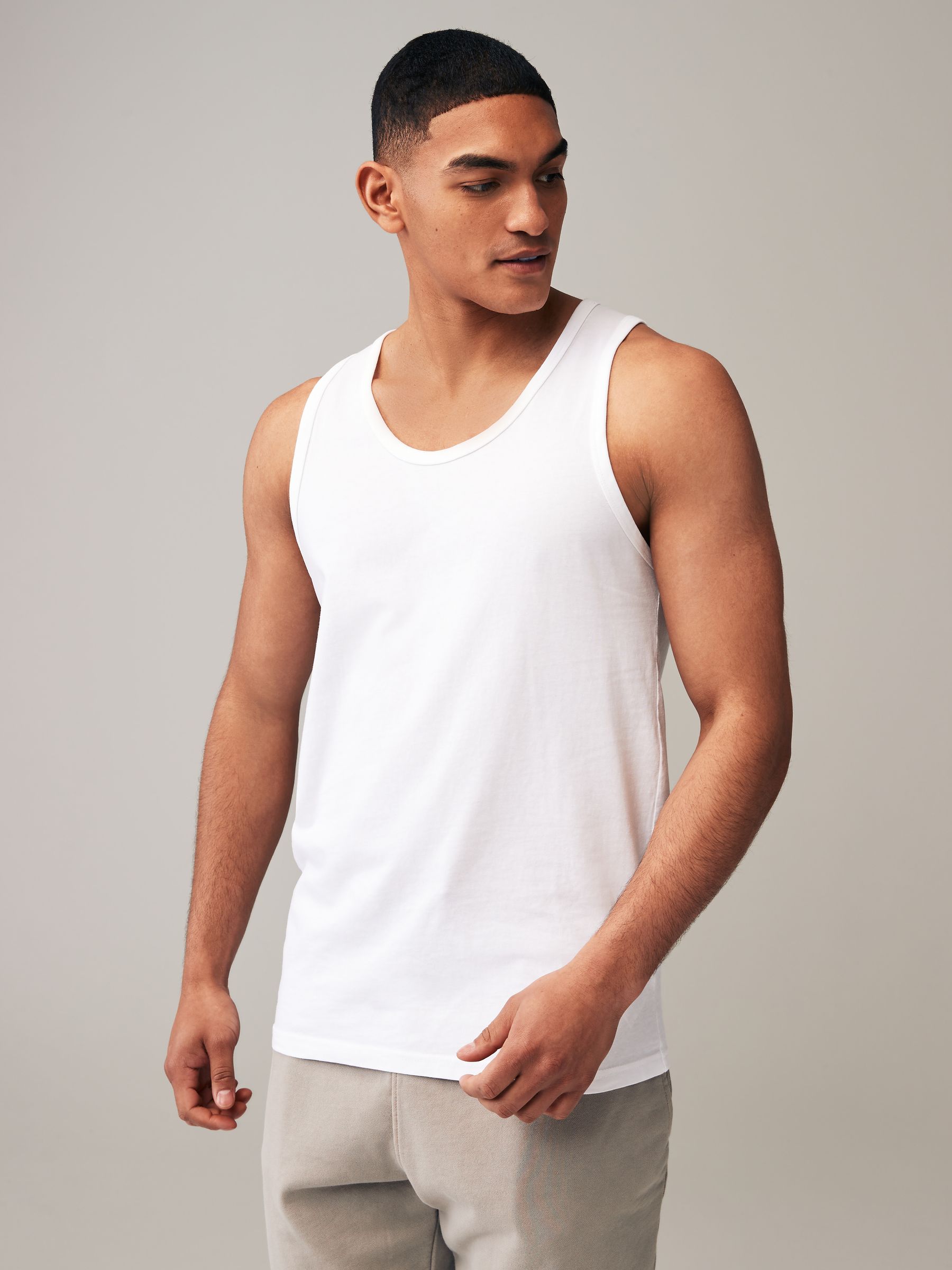 Buy Black/Navy/White/Blue 100% Cotton Vests 4 Pack from Next Buy Black/Navy/White/Blue 100% Cotton Vests 4 Pack from Next