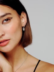 All We Are Silver Tone Spina Crystal Thorn Huggie Earrings - Image 1 of 7
