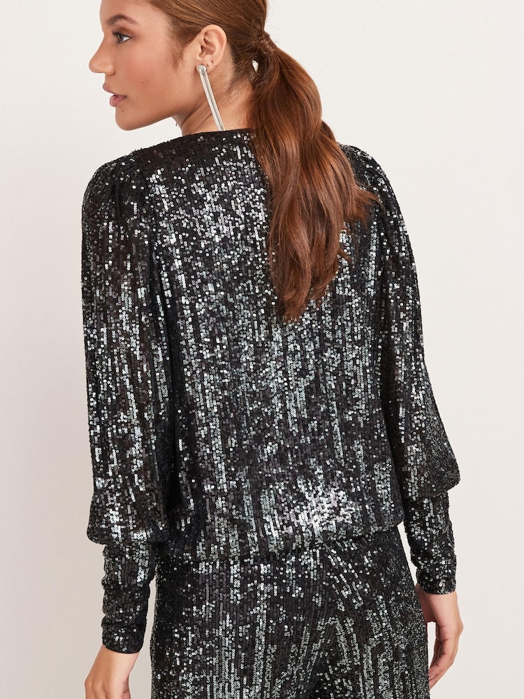 Schwarz - Next Langärmelige Pailletten-Partybluse mit Wickeldesign und V-Ausschnitt - Bild 2 von 5 Schwarz - Next Langärmelige Pailletten-Partybluse mit Wickeldesign und V-Ausschnitt - Bild 2 von 5