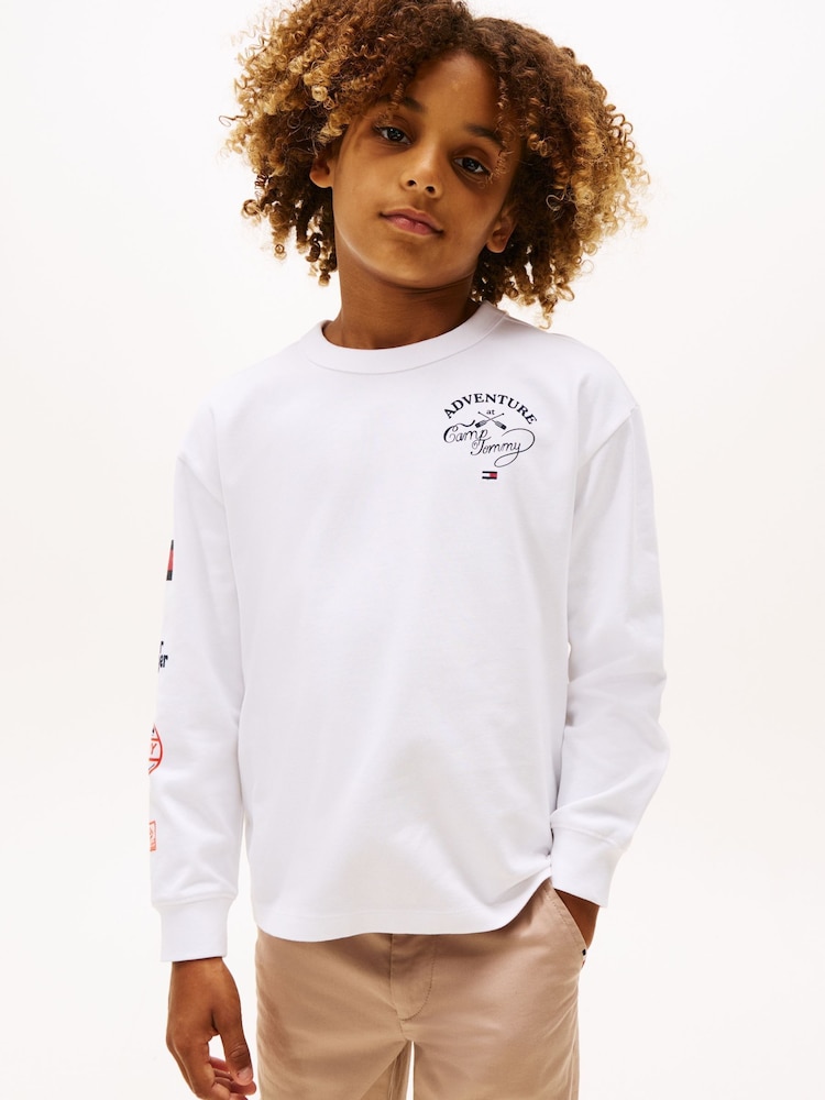 Tommy Hilfiger White Multi-Badge Long Sleeve T-Shirt - Image 1 of 5 Tommy Hilfiger White Multi-Badge Long Sleeve T-Shirt - Image 1 of 5