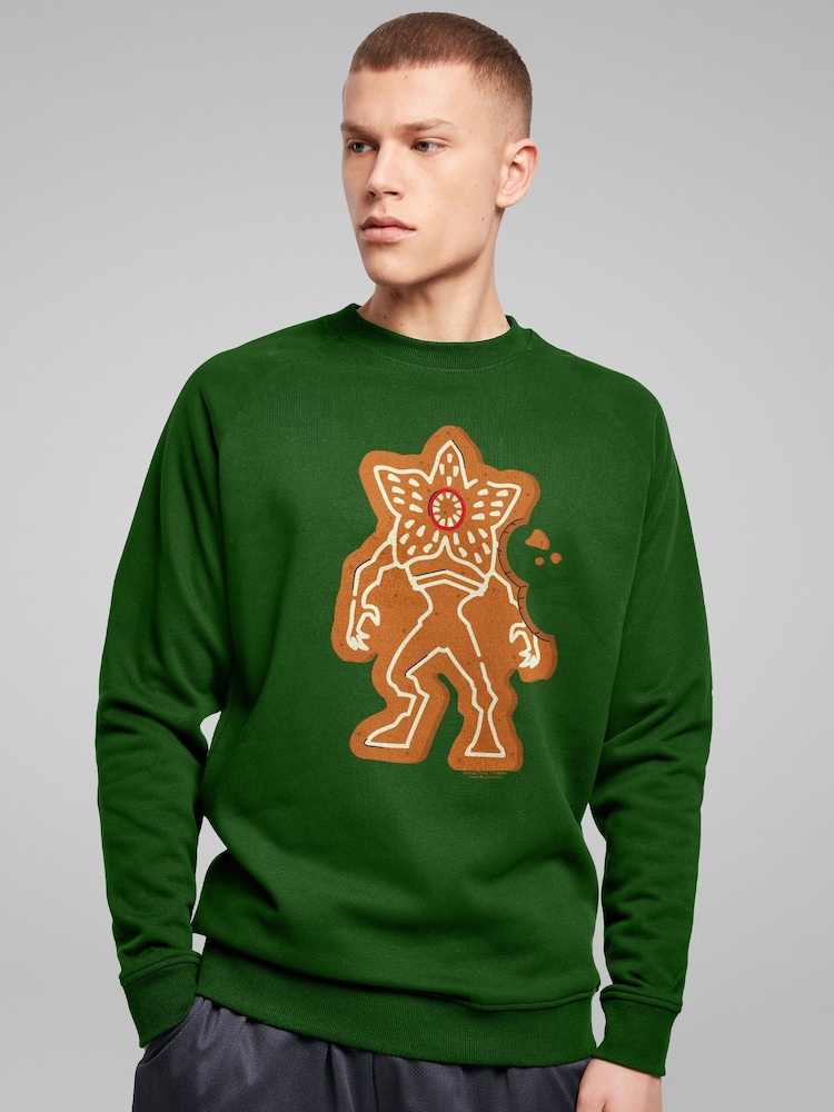All + Every Green Stranger Things Christmas Gingerbread Demogorgon Sweatshirt - Image 1 of 4 All + Every Green Stranger Things Christmas Gingerbread Demogorgon Sweatshirt - Image 1 of 4