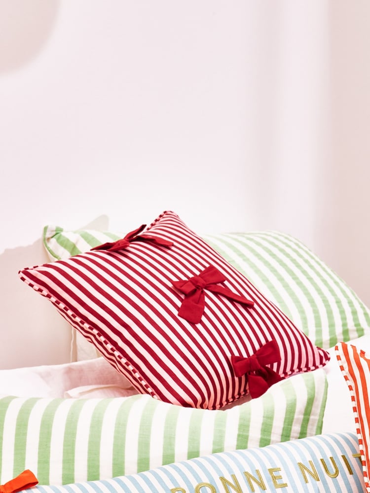 Oliver Bonas Pink Burgundy Stripe Cotton Bow Cushion Cover 45x45cm - Image 1 of 5 Oliver Bonas Pink Burgundy Stripe Cotton Bow Cushion Cover 45x45cm - Image 1 of 5
