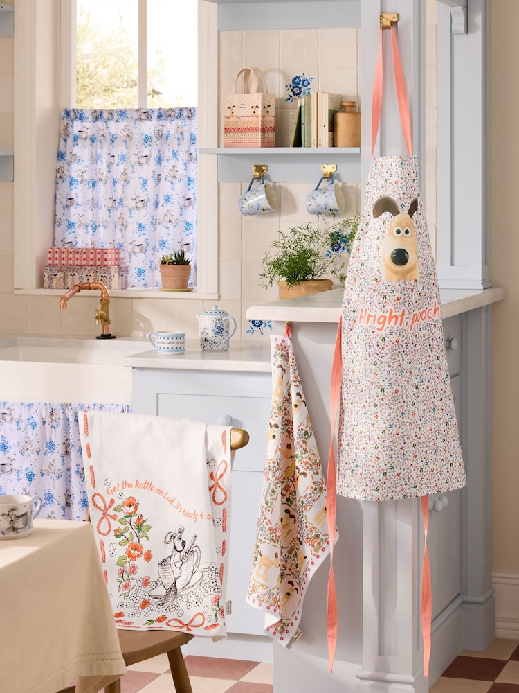 Cath Kidston Set of 2 Orange/White Wallace and Gromit Tea Towels and Apron - Image 1 of 4 Cath Kidston Set of 2 Orange/White Wallace and Gromit Tea Towels and Apron - Image 1 of 4