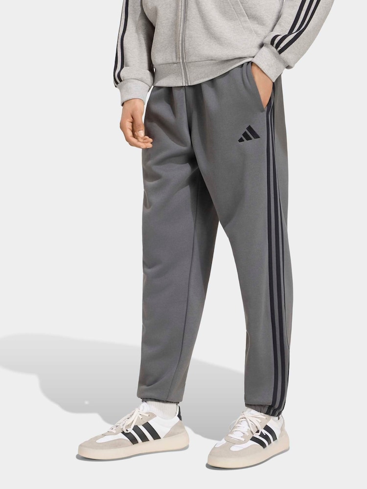 adidas Grey Essentials 3-Stripes Fleece Tapered Cuffed Pants - Image 1 of 6 adidas Grey Essentials 3-Stripes Fleece Tapered Cuffed Pants - Image 1 of 6