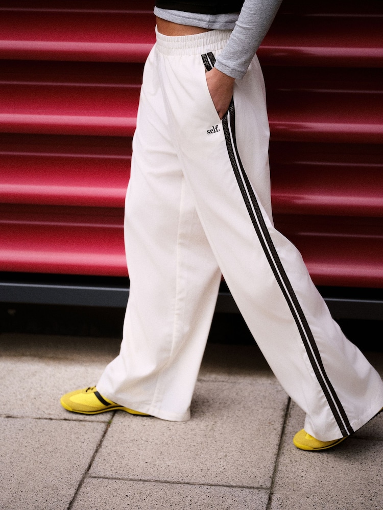self. Ecru Wide Leg Viscose Blend Track Trousers With Side Stripe - Image 1 of 9 self. Ecru Wide Leg Viscose Blend Track Trousers With Side Stripe - Image 1 of 9