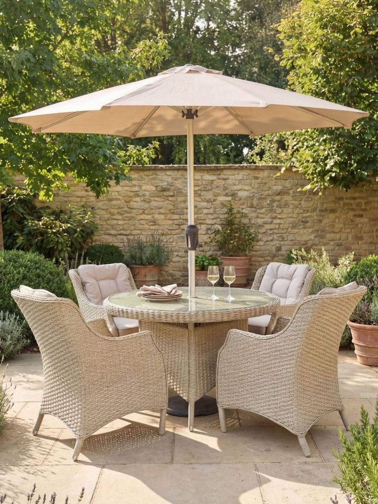 Bramblecrest Sandstone Woodchester 120cm Round Table with 4 Dining Armchairs & Parasol - Image 1 of 6 Bramblecrest Sandstone Woodchester 120cm Round Table with 4 Dining Armchairs & Parasol - Image 1 of 6