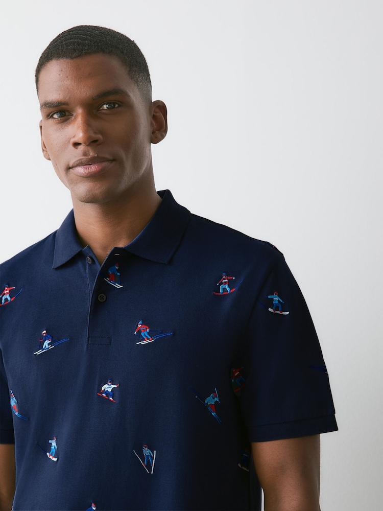 Navy Christmas Ski Embroided Short Sleeve Motionflex Polo Shirt - Image 1 of 7 Navy Christmas Ski Embroided Short Sleeve Motionflex Polo Shirt - Image 1 of 7