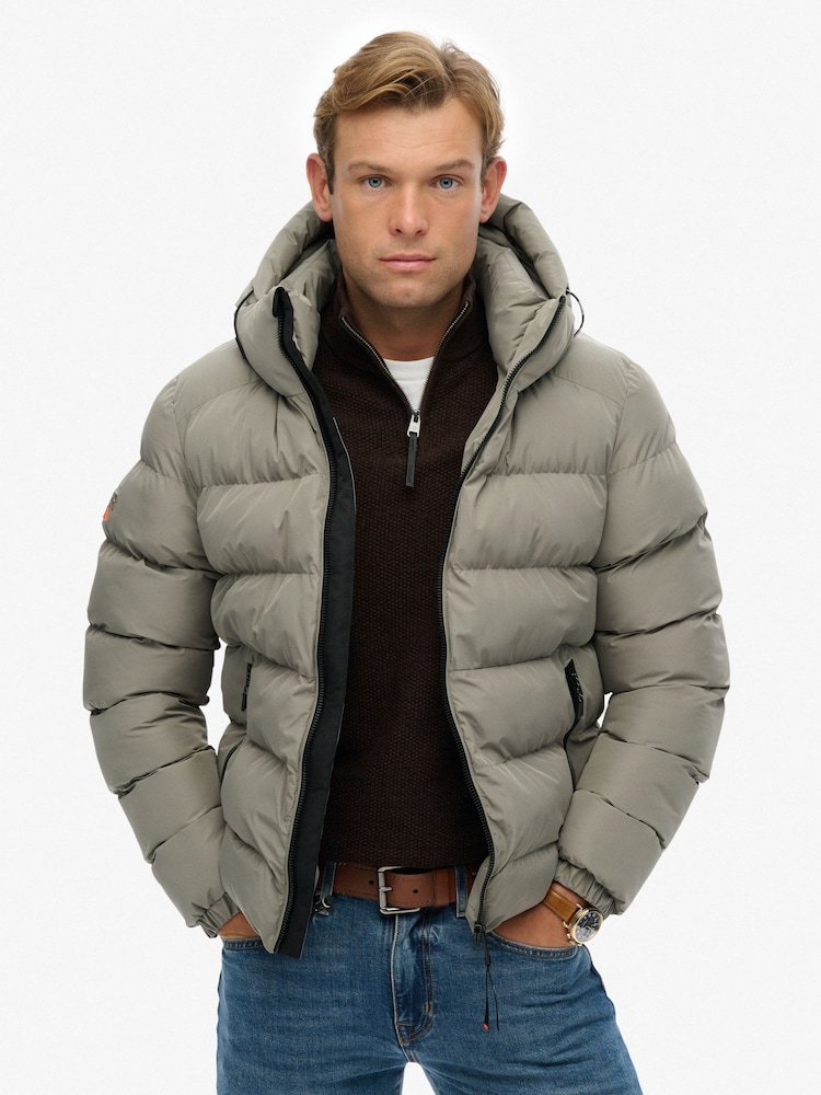 Superdry Light Khaki Green Hooded Sports Puffer Jacket - Image 1 of 7 Superdry Light Khaki Green Hooded Sports Puffer Jacket - Image 1 of 7