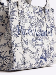 حقيبة نسائية متوسطة الحجم بتصميم جاكار بطبعة زهور من River Island - صورة 7 من 11