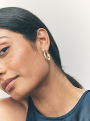 Gold Tone Crossover Hoop Earrings - Image 1 of 7