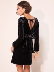 Friends Like These Black Petite Long Sleeve Velvet Bow Back Mini Dress - Image 1 of 4
