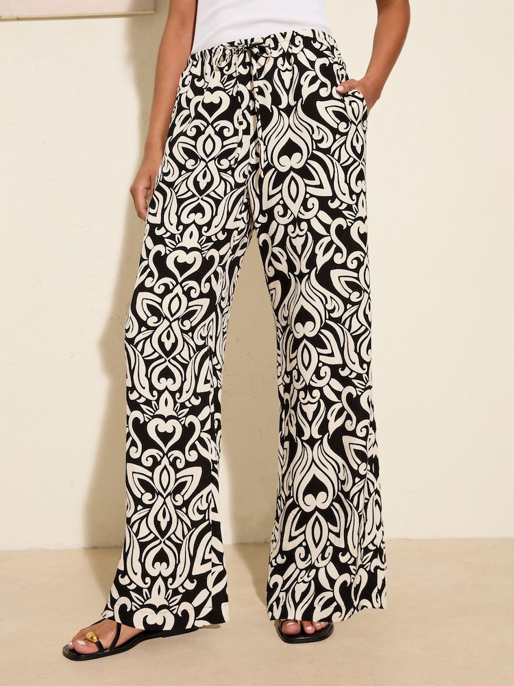 Friends Like These Black Floral Crinkle Jersey Wide Leg Trousers - Image 1 of 4 Friends Like These Black Floral Crinkle Jersey Wide Leg Trousers - Image 1 of 4