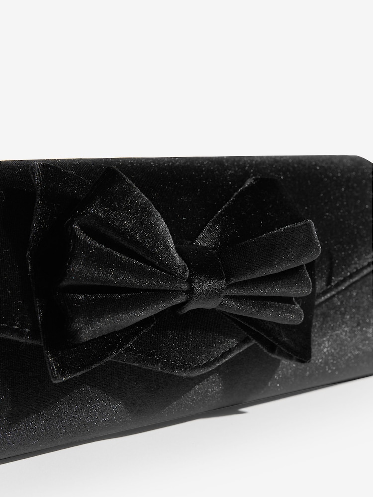 Buy Lipsy Black Velvet Bow Clutch Bag from Next Oman
