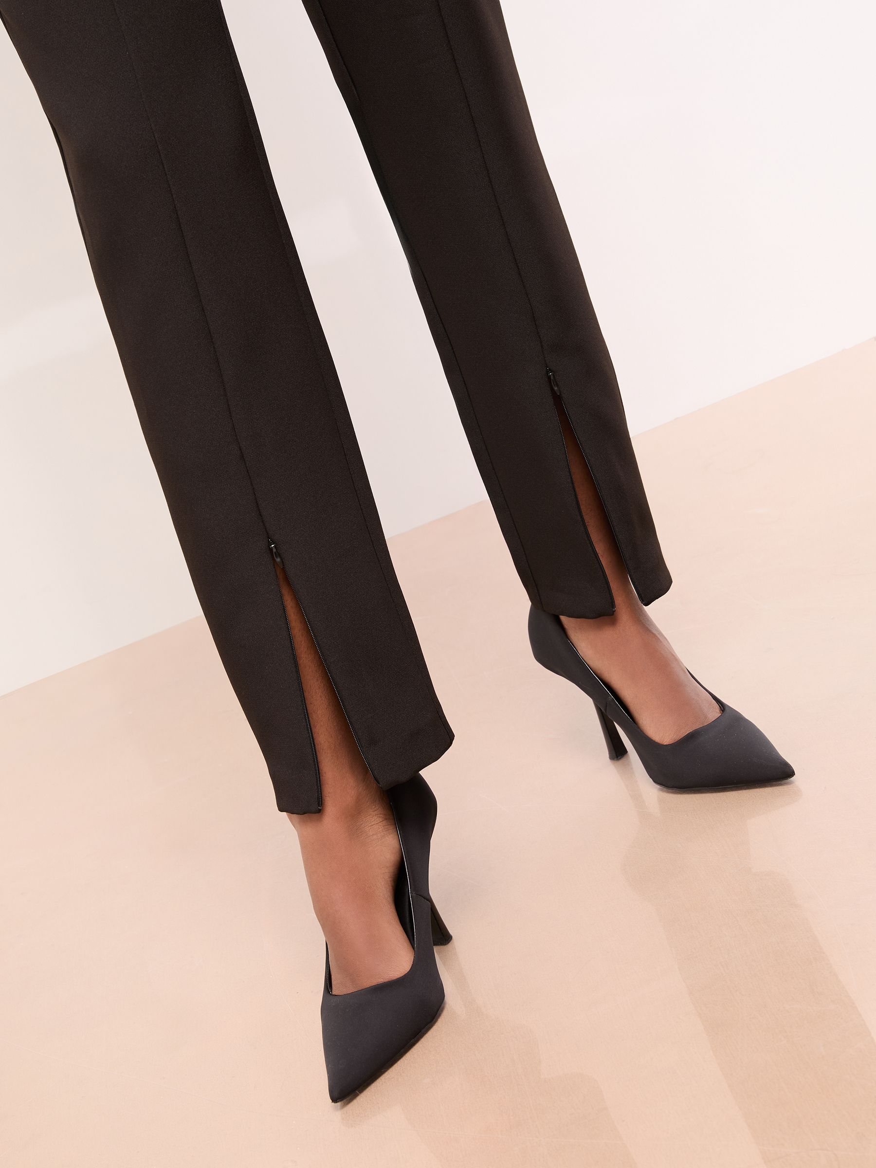 Buy Lipsy Black Zip Up Hem Tailored Tapered Trousers from the Next