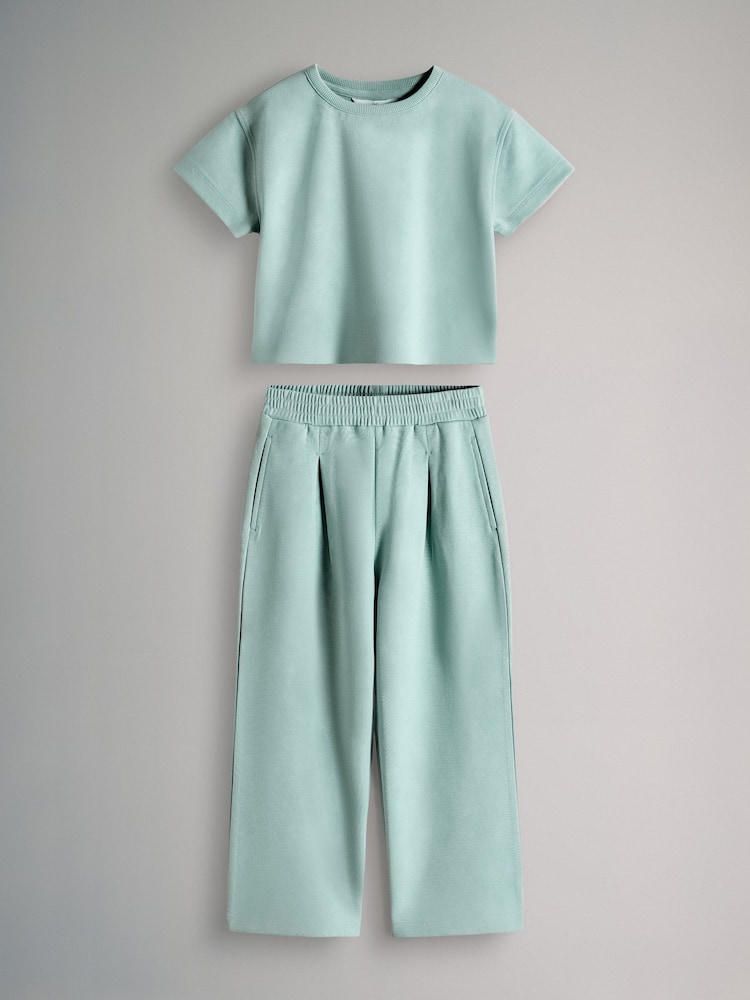 The Set Interlock Cropped Short Sleeve T-Shirt and Wide Leg Joggers Set Teal Blue - Image 1 of 5 The Set Interlock Cropped Short Sleeve T-Shirt and Wide Leg Joggers Set Teal Blue - Image 1 of 5