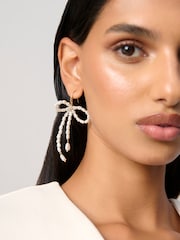 Aela Cream Pearl Bow Drop Earrings - Image 1 of 3