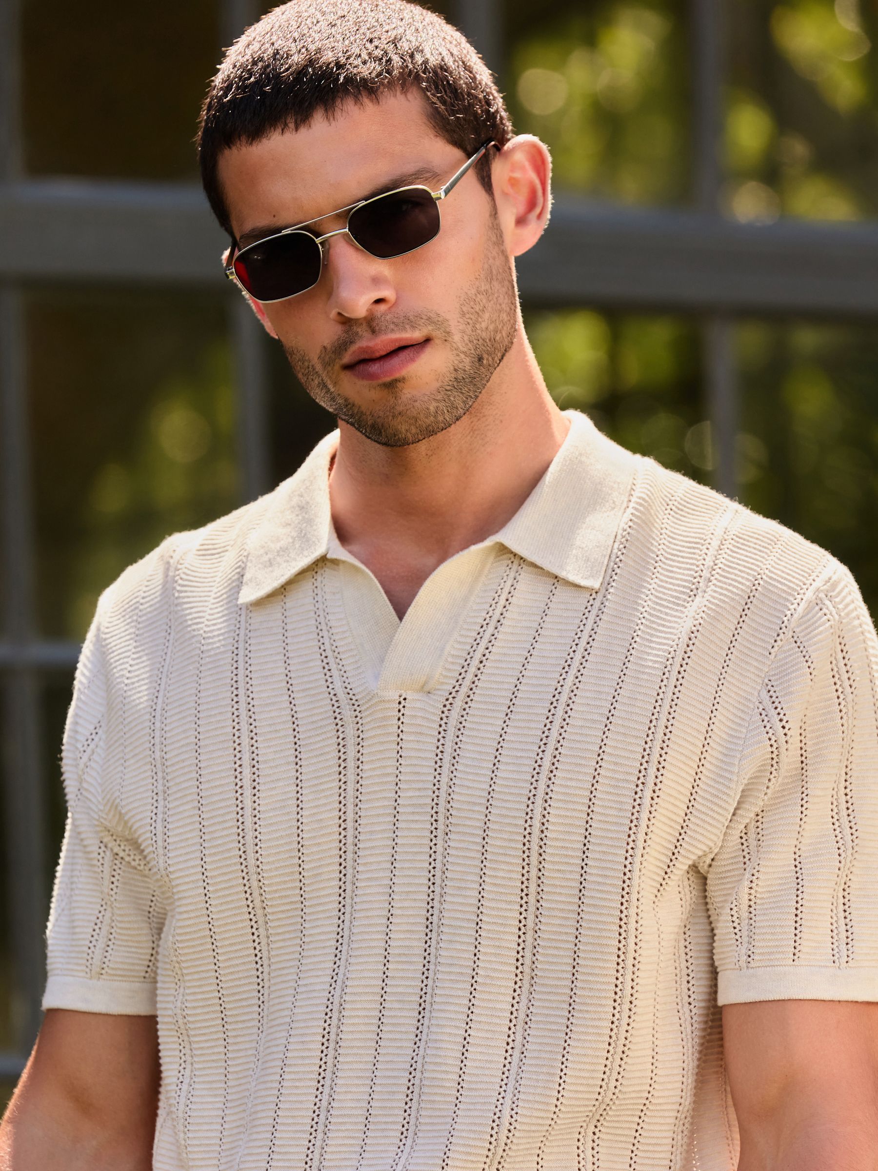 Buy Neutral Textured Knit Trophy Polo Shirt from Next United Arab