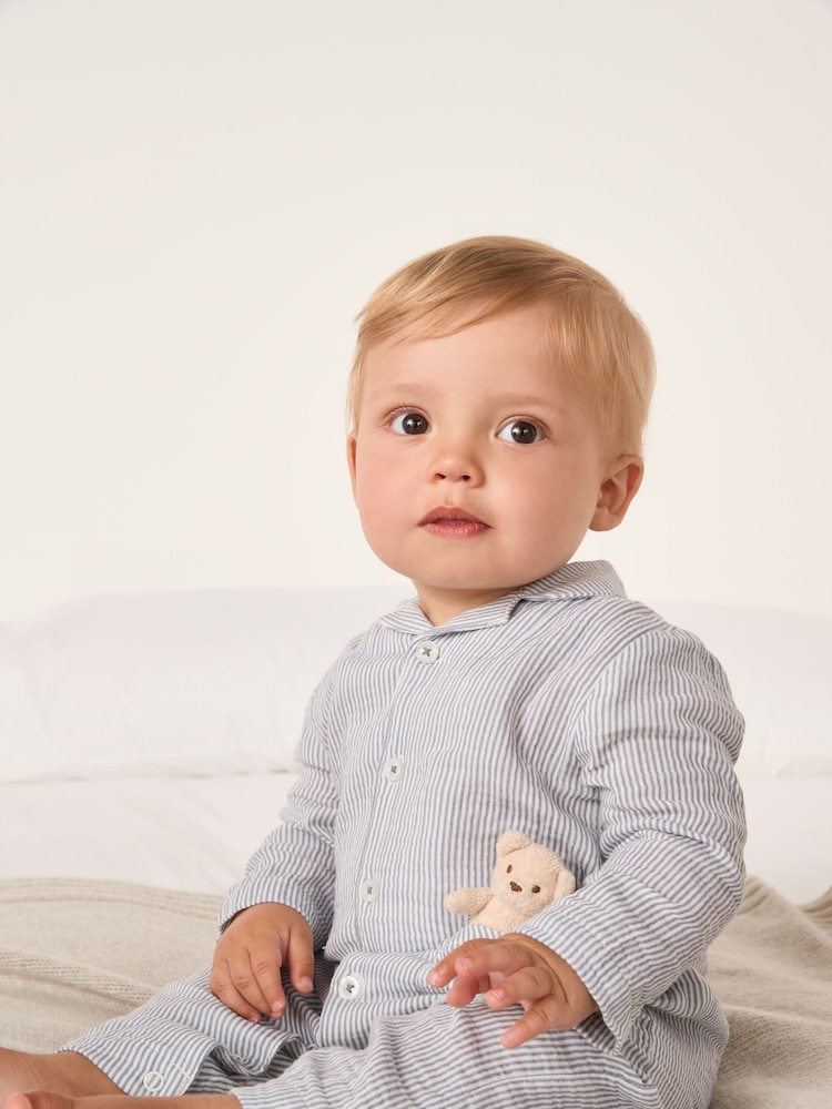 The White Company Blue Crinkle Stripe Bear Toy Classic Sleepsuit - Image 1 of 5 The White Company Blue Crinkle Stripe Bear Toy Classic Sleepsuit - Image 1 of 5