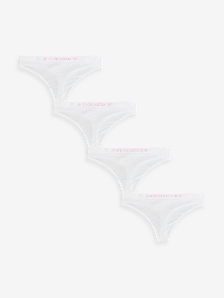 Victoria's Secret White Thong 4 Pack Logo Knickers - Image 1 of 3 Victoria's Secret White Thong 4 Pack Logo Knickers - Image 1 of 3